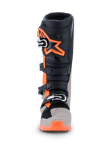 Alpinestars 2026 Tech 7 Enduro Boots, Motocross and Enduro Boots, Black Warm Gray and Orange Fluo, front view featuring large orange star logo on the shin, multi-buckle closure system, and rugged protective panels for off-road performance.