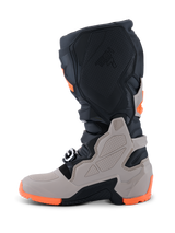 Alpinestars 2026 Tech 7 Enduro Boots, Motocross and Enduro Boots, Black Warm Gray and Orange Fluo, side view featuring a rugged dual-compound sole, TPU shielding on the shin and ankle, and embossed Tech 7 branding.