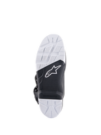 Alpinestars Tech 7 Enduro Boots, sole view showing the specifically engineered compound outsole, black and white dual-tone design with textured grip patterns, featuring the white star logo and a replaceable footpeg insert.