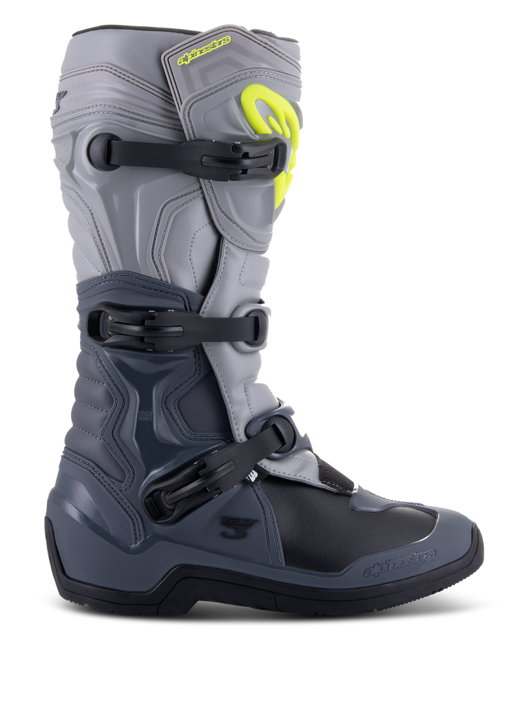 Alpinestars Tech 3 Stiefel, Motocross-Stiefel, Dunkelgrau, Hellgrau und Schwarz, Seitenansicht mit drei schwarzen Polymerschnallen, TPU-Schutzpaneelen und einem leuchtend gelben Alpinestars-Logo im oberen Schienbeinbereich