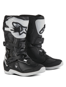 Alpinestars Youth Tech 3S Boots, Motocross Boots for young riders, Black and White, featuring three adjustable buckle straps, white TPU shin plate with Alpinestars logo, reinforced hard shell protection, and a sturdy white treaded sole, off-road racing design