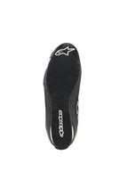 Alpinestars Celer Superair Shoes, Motorcycle Riding Shoes, Black and White, bottom view showing the oil-resistant rubber outsole with textured tread, white Alpinestars logo on the heel and brand name along the center for grip and performance