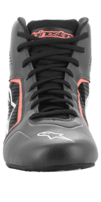 Alpinestars Tech-1 K Start V2 Shoes, Karting Shoes, Asphalt Black and Orange Fluo, front-facing view showing black laces, orange Alpinestars branding on the tongue, white star logo on the toe, and perforated microfiber panels