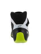 Alpinestars Tech-1 KX V3 Schuhe, FIA-zertifizierte Kartschuhe, Schwarz Weiß und Gelb Fluo, Rückansicht mit verstärktem einteiligem Fersenbereich, leuchtender gelber Fluo-Akzent, weiße Einsätze mit schwarzem Logo, technisches Motorsport-Schuhwerk für den Einsatz auf der Rennstrecke.