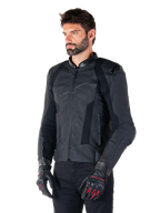 Male rider wearing the Alpinestars Missile V3 Leather Jacket in Black, premium bovine leather with perforated chest panels and external DFS shoulder protectors, paired with black pants and black/red racing gloves.