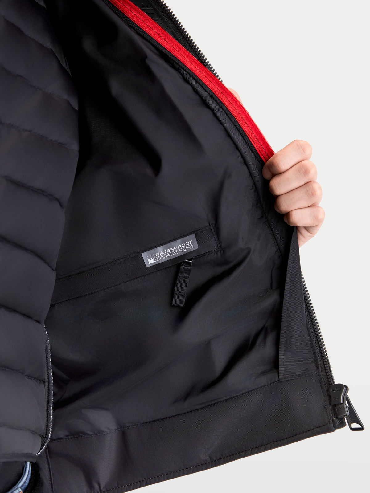 Alpinestars Revern Leather Jacket, men's urban motorcycle leather jacket, interior detail showing removable thermal vest lining, waterproof storage compartment, and red zipper accent, black