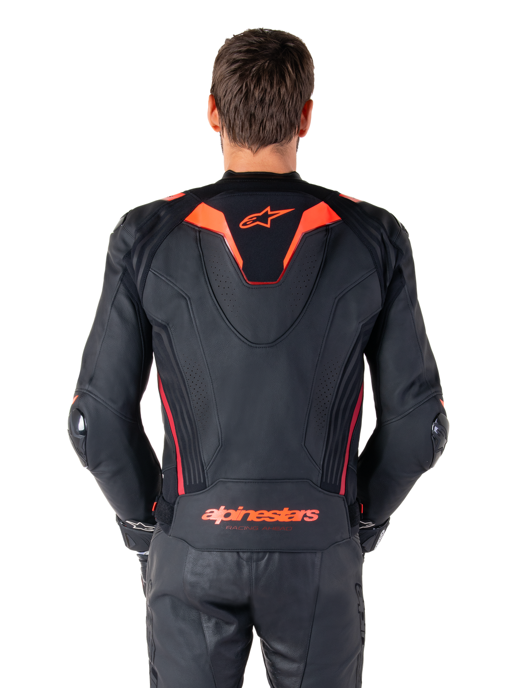 Alpinestars Missile V3 Ignition Lederjacke, Rückansicht, Schwarz mit Akzenten in Red Fluo und Dark Red, mit sportlichem Aero-Höcker, Alpinestars-Branding auf dem Rücken, getragen mit passender schwarzer Leder-Motorradhose, Performance-Motorrad-Rennausrüstung