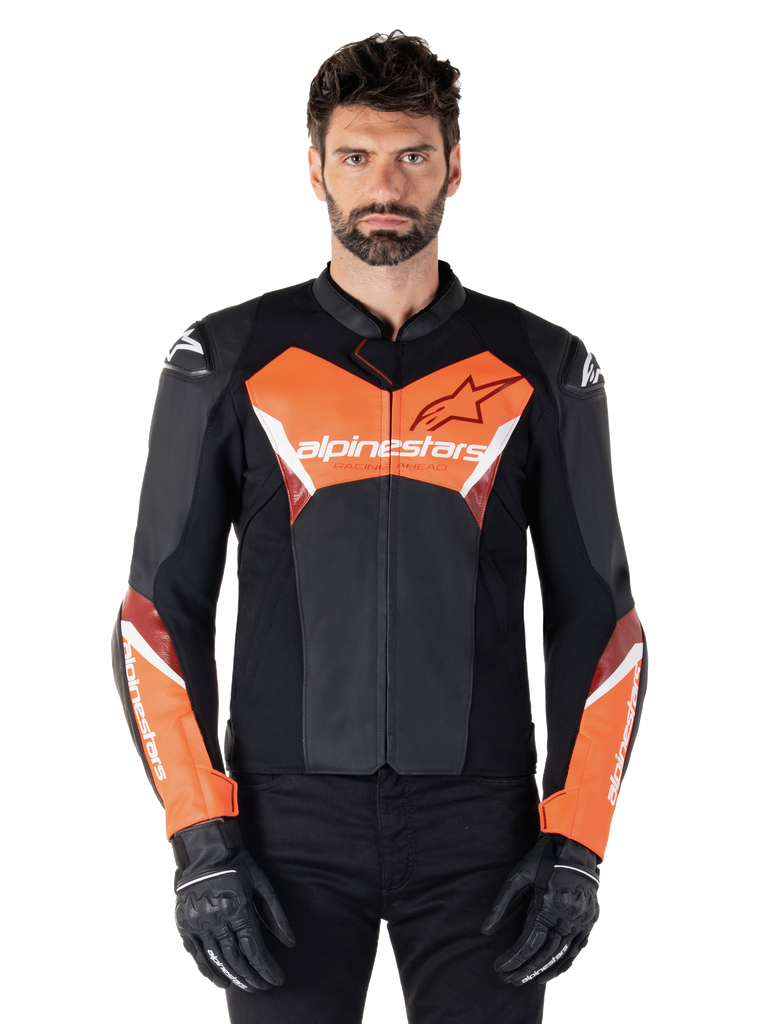 Alpinestars Faster V3 Lederjacke, Sport-Motorradjacke, Schwarz und Rot Fluo, getragen von einem männlichen Model mit schwarzen Motorradhandschuhen und -hosen, mit markantem Alpinestars-Branding auf Brust und Unterarmen, hochwertige Lederkonstruktion für den Straßeneinsatz.