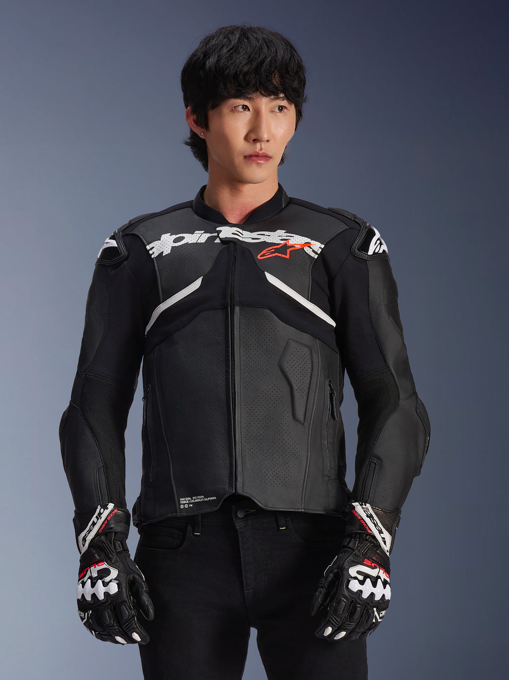 Alpinestars Atem V5 Leather Jacket, Motorcycle Racing Jacket, Black with White and Red Accents, premium leather construction with armored protection, worn with matching racing gloves