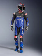 Yamaha GP-R7 One Piece Leather Suit, Motorcycle Racing Suit, Metallic Blue and Black, Red and White accents, features Yamaha and GYTR branding, worn with matching helmet, racing gloves, and blue boots, professional performance gear