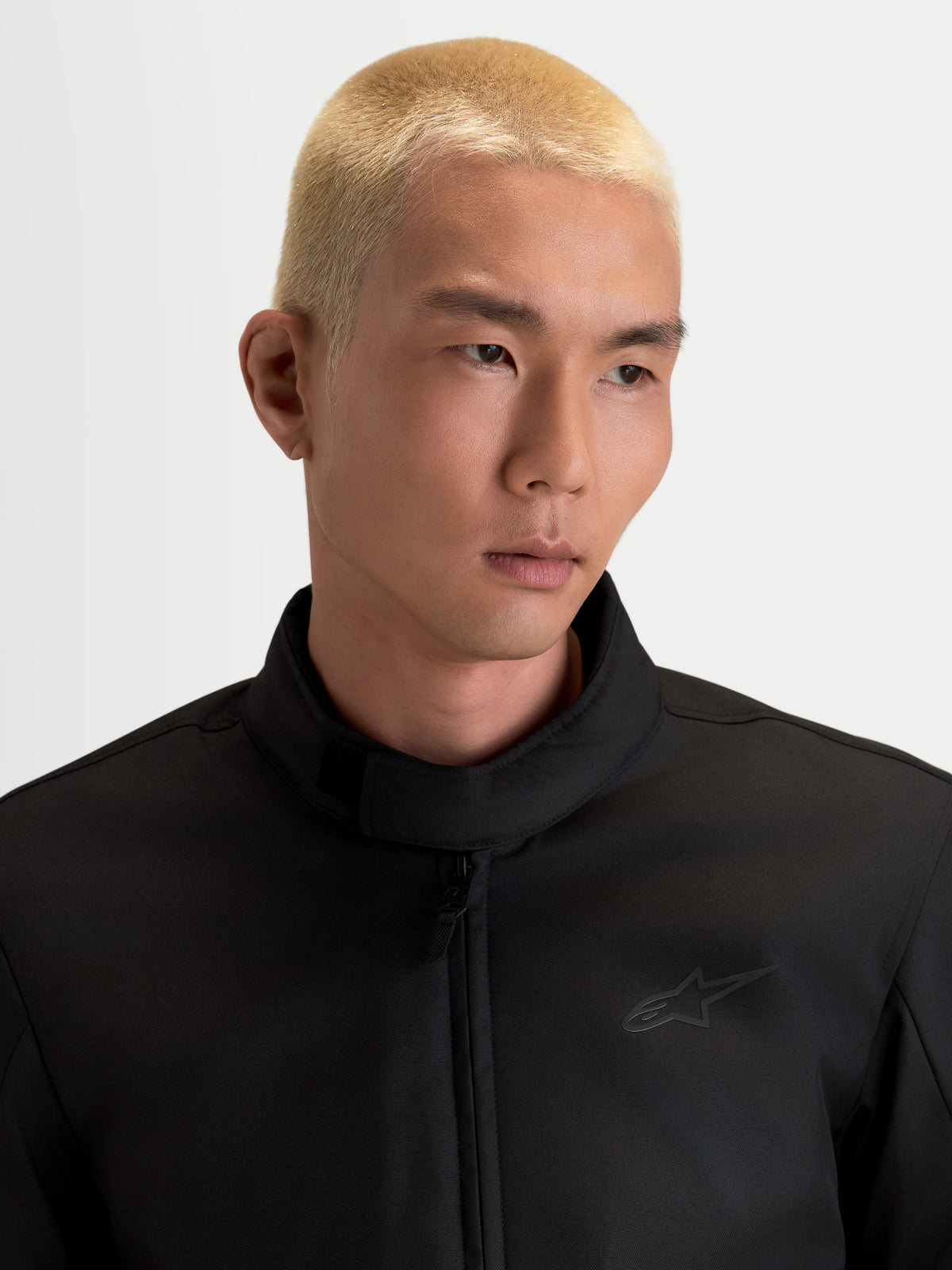 Alpinestars C-1 Waterproof Jacket, men's urban contemporary motorcycle textile jacket in black, close-up view showing the soft-finish collar and polyfabric construction worn by a model.