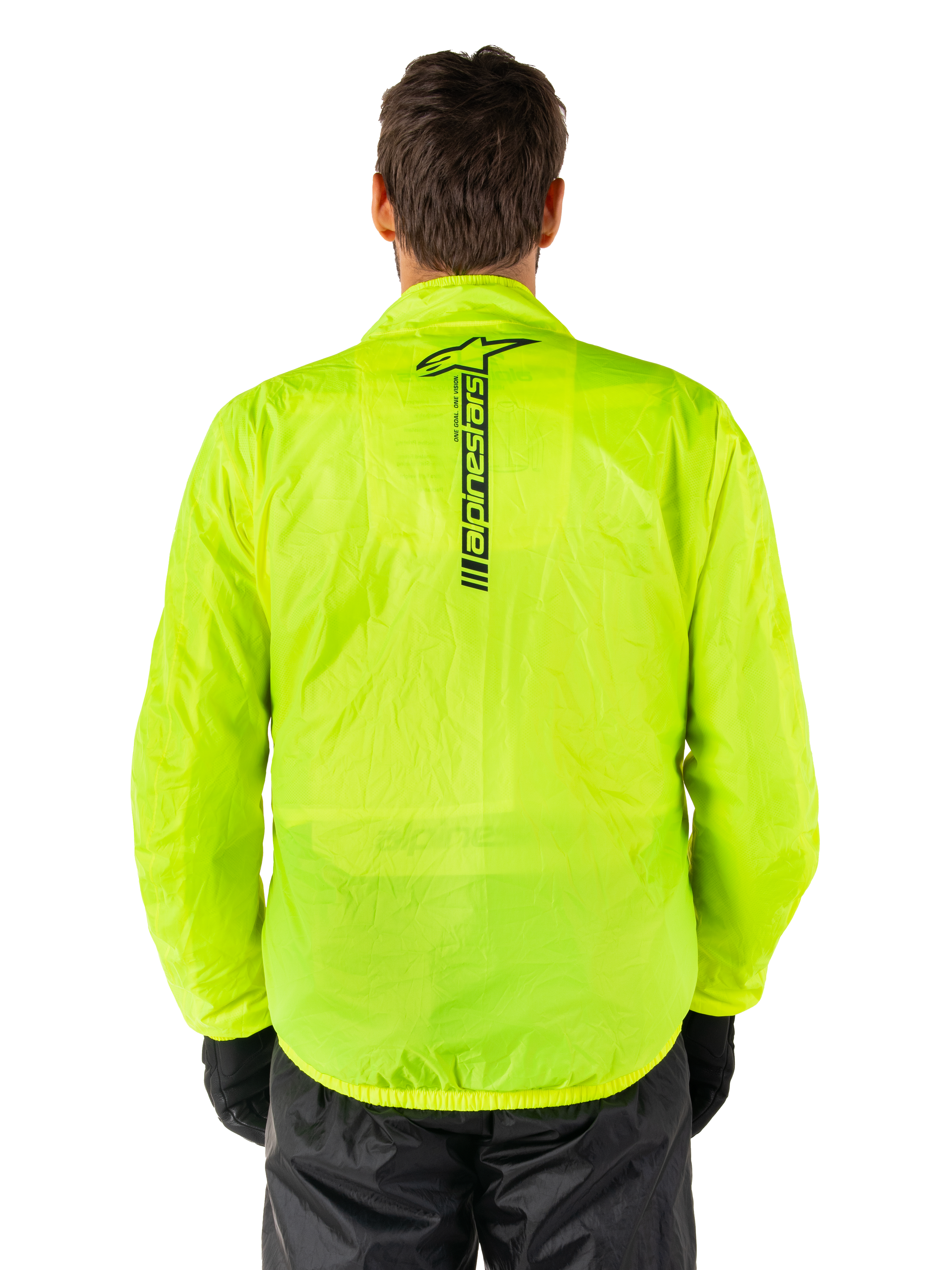Alpinestars Hurricane Rain V2 Jacket, Motorcycle Rain Jacket, Yellow Fluo, rear view showing vertical black Alpinestars logo on center back, lightweight waterproof fabric, worn with black riding pants and gloves
