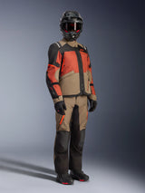 Alpinestars Andes V4 Drystar® Jacket in Walnut Rust Black, Adventure Touring Motorcycle Jacket, worn with matching walnut and black pants, black helmet, and riding boots, featuring a durable textile construction with multi-color panels for all-weather riding