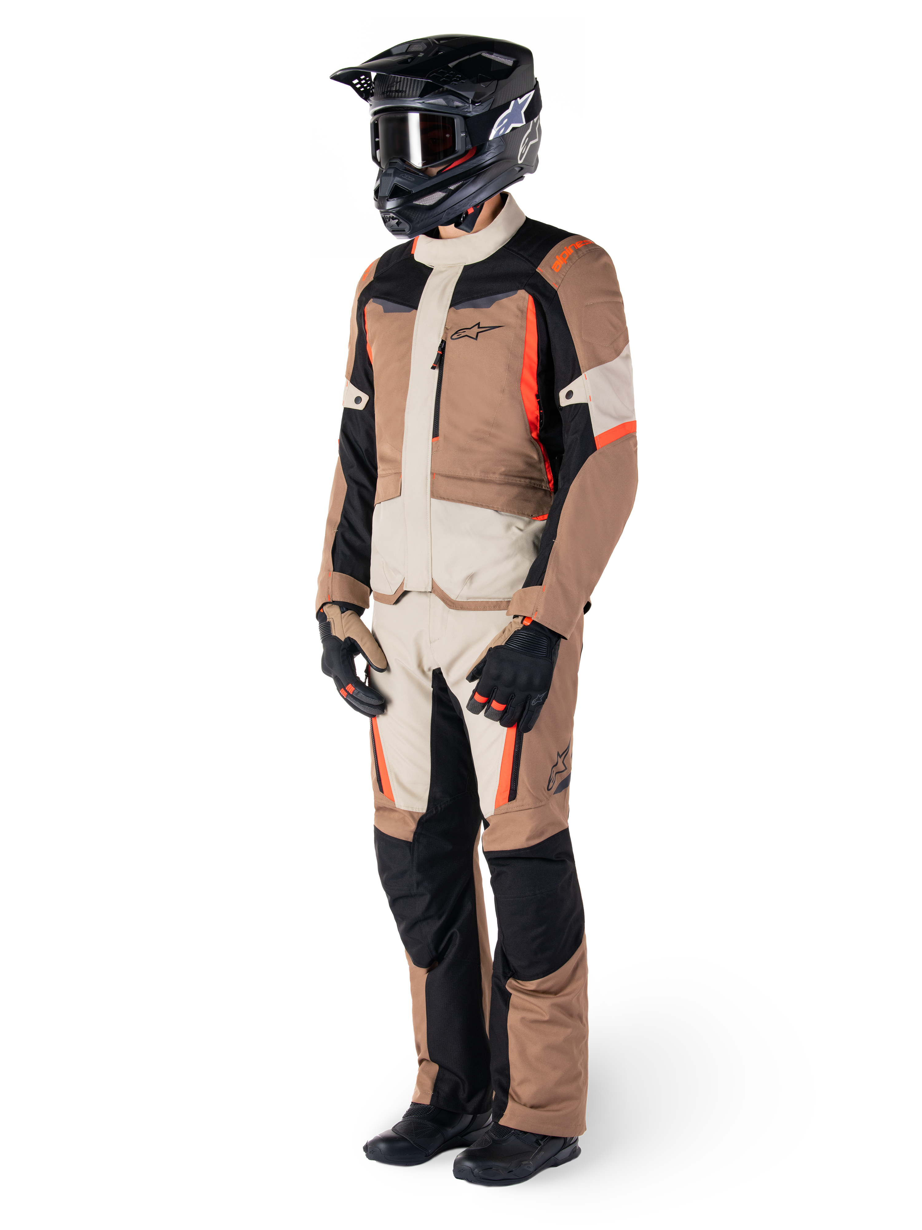 Alpinestars ST-1 Waterproof Jacket, Dark Khaki Sand Black Red Fluo, worn by a rider in full adventure touring gear with matching pants, black helmet, goggles, gloves, and boots, technical all-weather motorcycle outfit