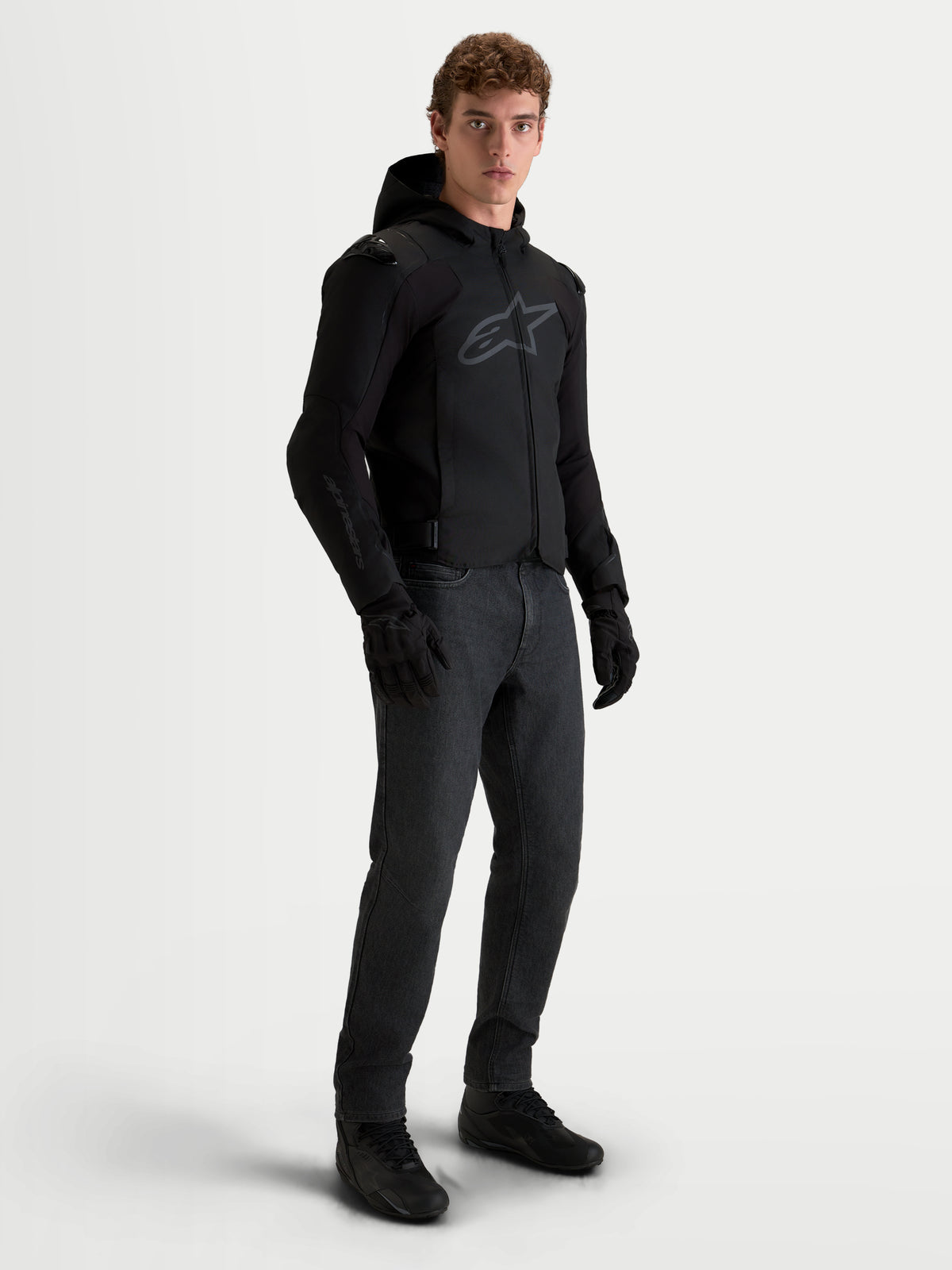 Alpinestars Zaca V2 Waterproof Jacket, Men's Black motorcycle textile jacket with hood, CE AA certified protection and stretch softshell mobility, worn by a model
