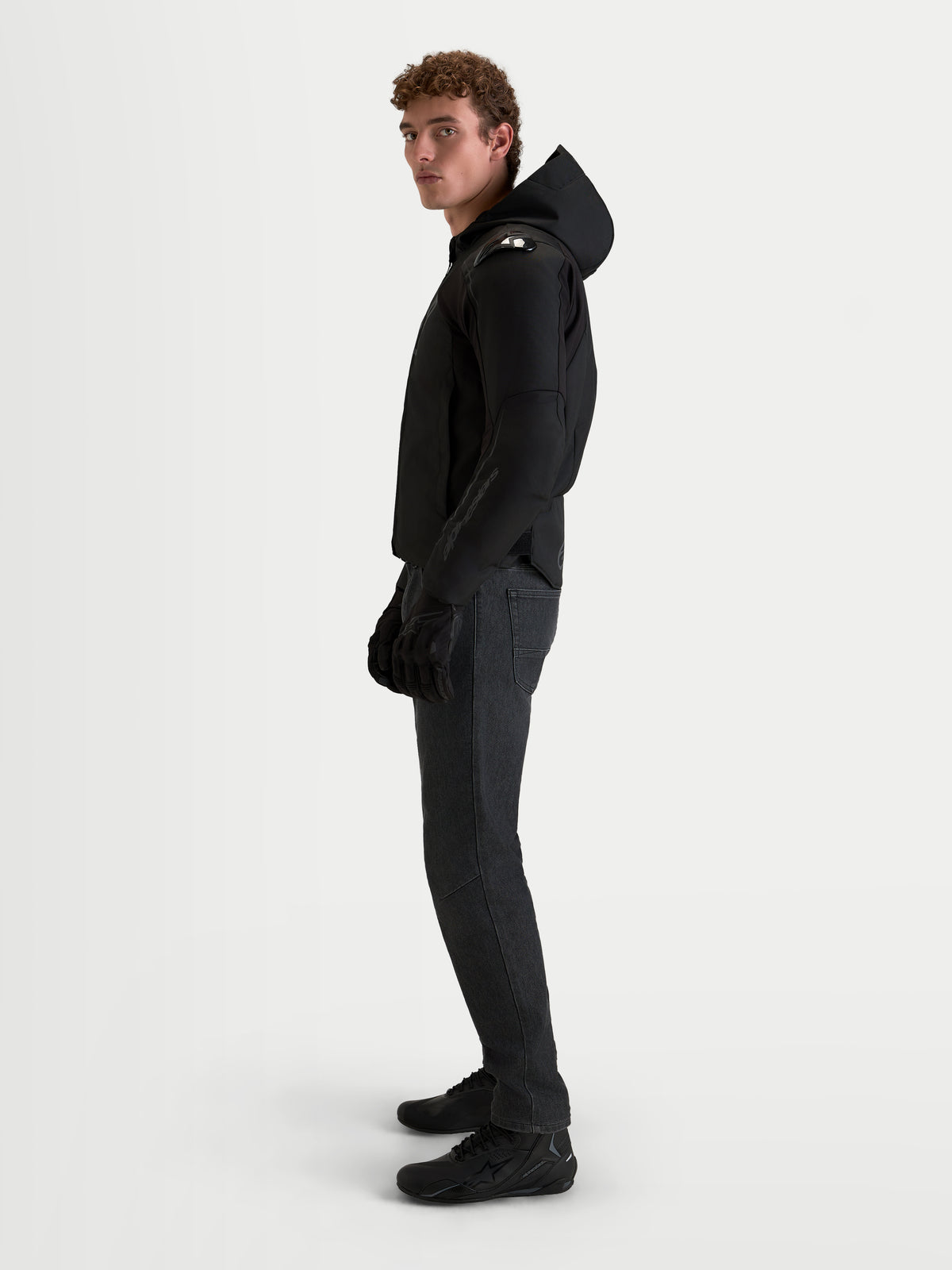 Alpinestars Zaca V2 Waterproof Jacket, Men's Black motorcycle racing sport textile jacket featuring a hood and integrated shoulder armor, worn by a model