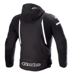 Alpinestars Zaca Waterproof Jacket, Motorcycle Jacket, Black and White, rear view showing detachable hood with white star logo, vertical white stripes on the back, Alpinestars branding on the lower hem, and ribbed stretch panels for mobility.
