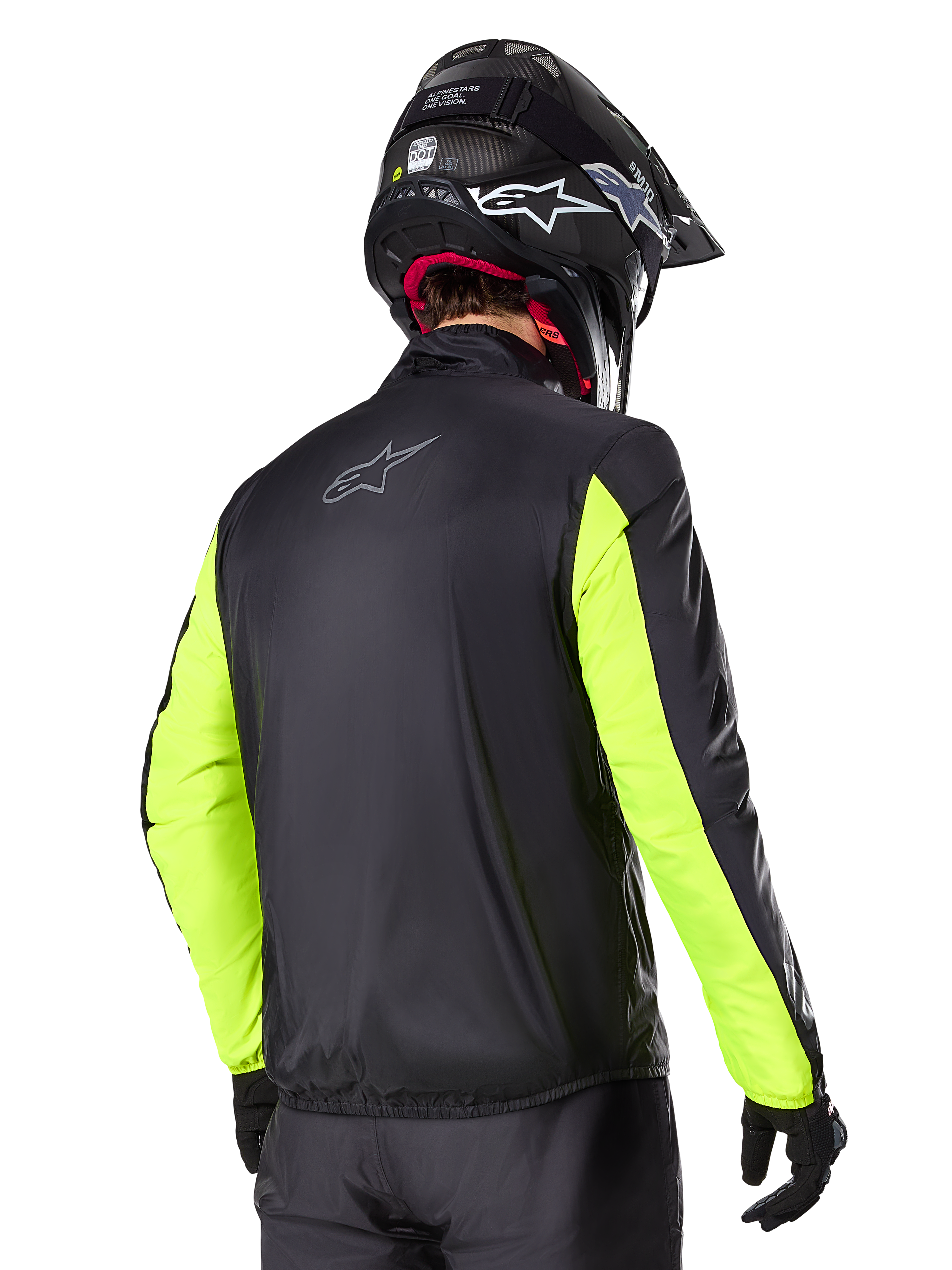 Alpinestars Bogotá Pro Drystar® Jacke, Rückansicht, Schwarz mit Gelb Fluo Ärmeln, getragen von einem Fahrer mit schwarzem Helm und Handschuhen, hochsichtbare Adventure-Touring-Motorradausrüstung mit technischem Textil-Finish.