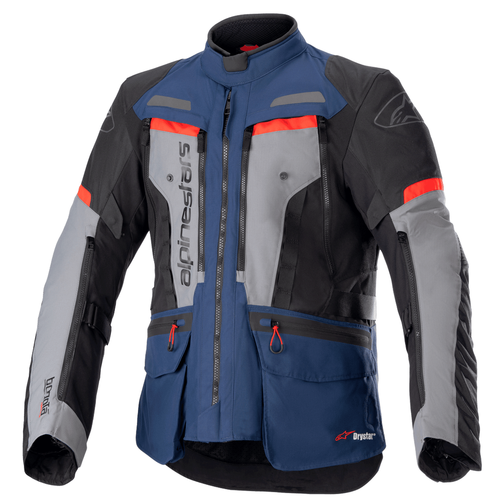 Alpinestars Bogota Pro Drystar Jacke, Motorrad-Adventure-Tourenjacke, Dunkelblau und Schwarz mit grauen Brustpaneelen und leuchtend roten Akzenten, wasserdichte Textilkonstruktion, mehrere Belüftungsreißverschlüsse und Funktionstaschen.