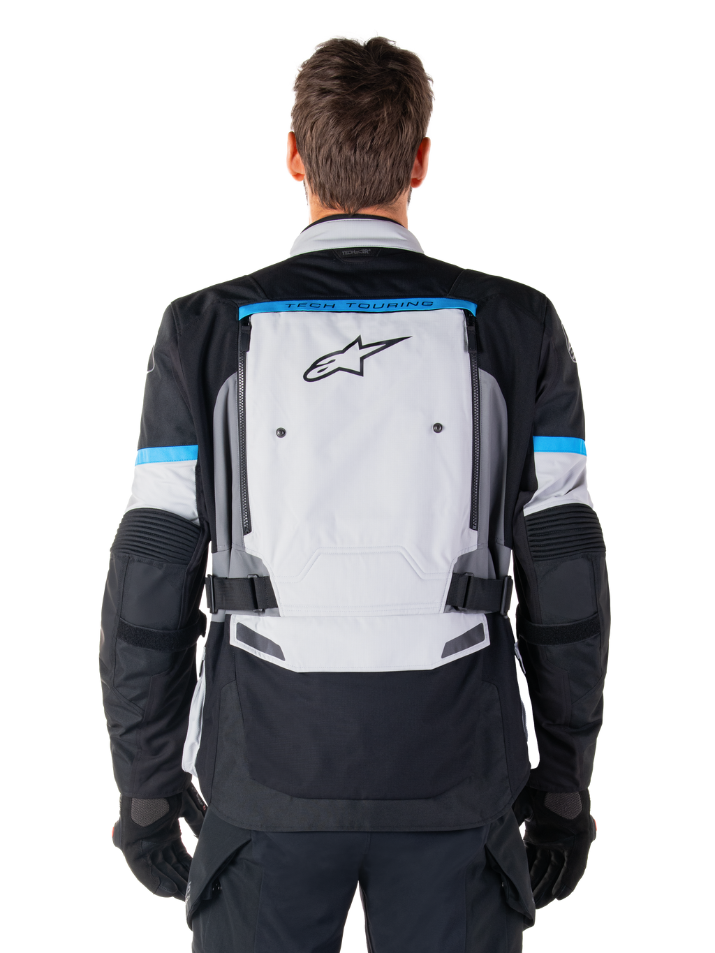 Alpinestars Bogota' Pro Drystar® Jacke, Adventure-Motorradjacke, Eisgrau, Schwarz und Cyan, Rückansicht mit einem großen hellgrauen Panel mit schwarzem Stern-Logo, cyanfarbenen Akzenten mit Tech-Touring-Branding und verstellbaren Taillengurten
