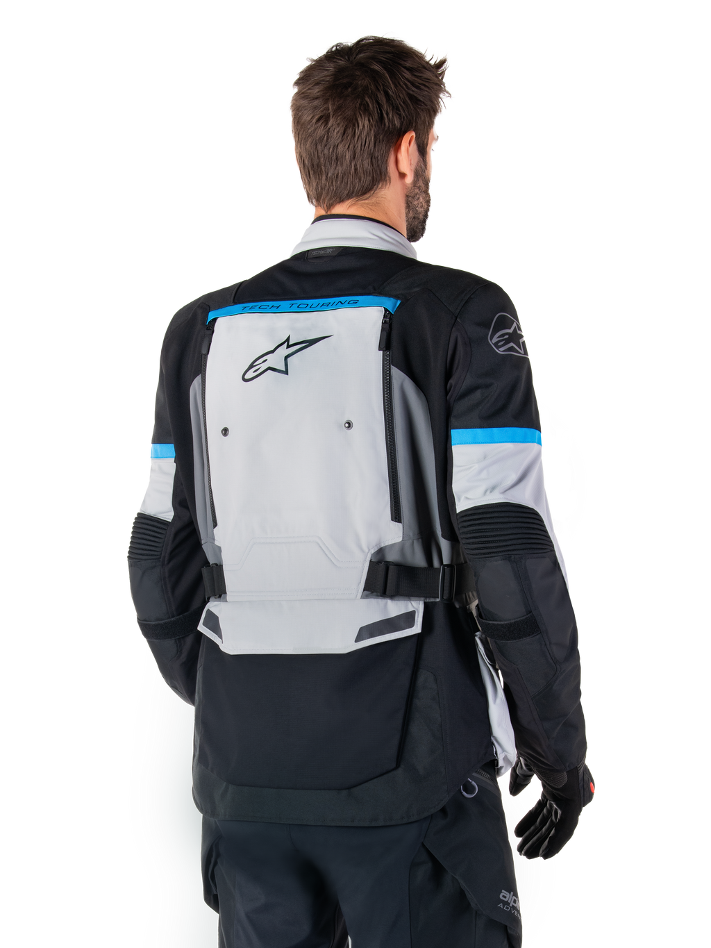 Alpinestars Bogota' Pro Drystar® Jacke, Adventure-Motorradjacke, Ice Gray, Schwarz und Cyan, Rückansicht mit Fokus auf dem großen grauen Rückenpanel mit Tech Touring-Branding, cyanfarbene Akzente an den Ärmeln, strapazierfähige Textilkonstruktion
