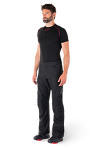 Alpinestars St-1 Waterproof Pants, Black, Adventure Touring Motorcycle Pants worn by a model with a black base layer and riding boots, featuring zippered pockets and reflective accents, durable textile construction for all-weather performance