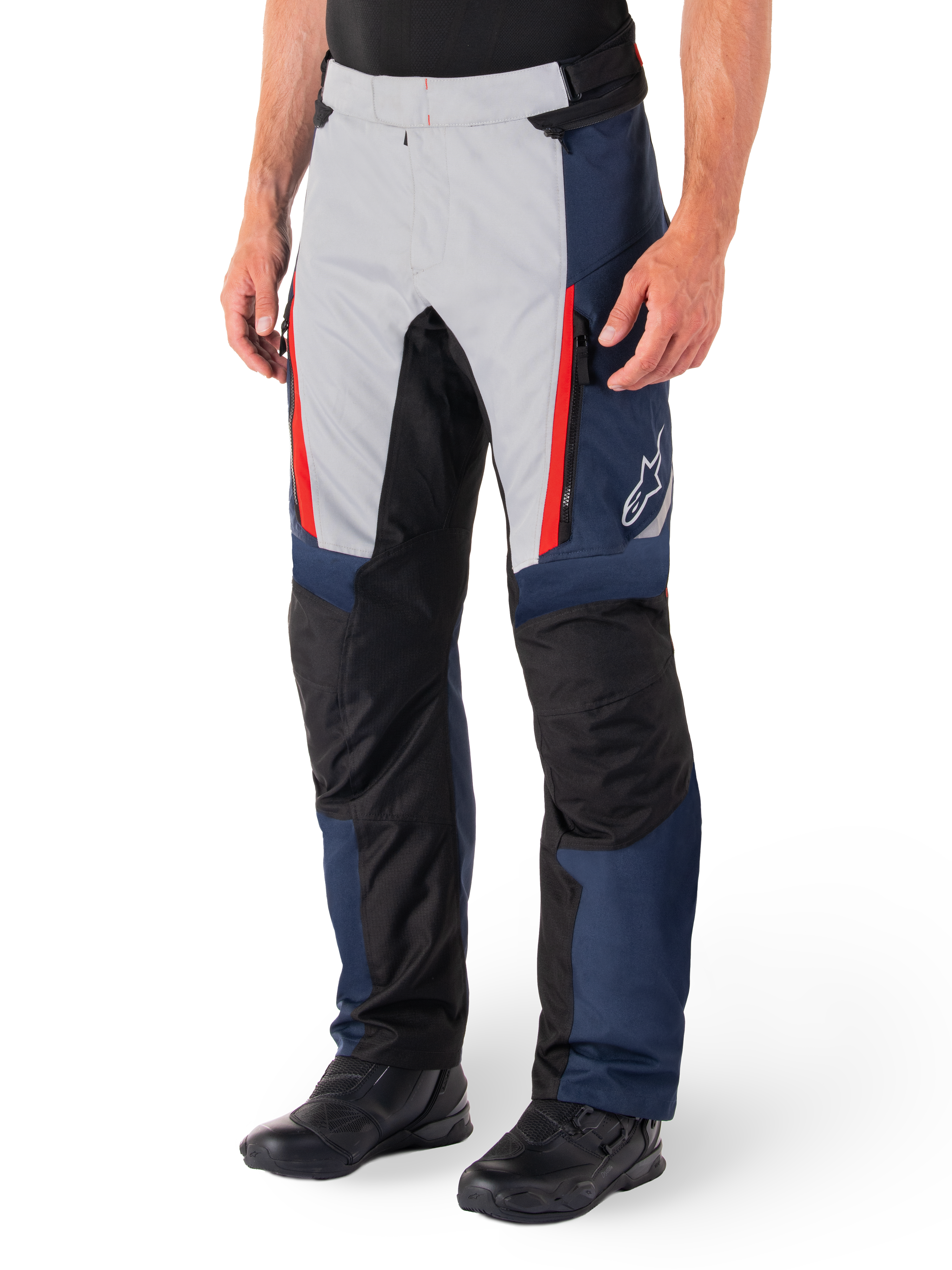 Alpinestars St-1 Waterproof Pants, Motorcycle Touring Pants, Dark Blue Black and Bright Red, featuring light grey front panels with red zipper accents, black reinforced knee sections, and a white Alpinestars logo on the side, worn with black motorcycle boots.
