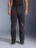 Alpinestars Andes Pro Drystar® XF Hose, Adventure-Touring-Motorradhose in Black Dark Gray, Frontansicht, mit 3-lagiger Laminatkonstruktion, integrierten Knieprotektoren, wasserdichten Reißverschlusstaschen und magnetischem Bundverschluss, kombiniert mit schwarzen Motorradstiefeln.