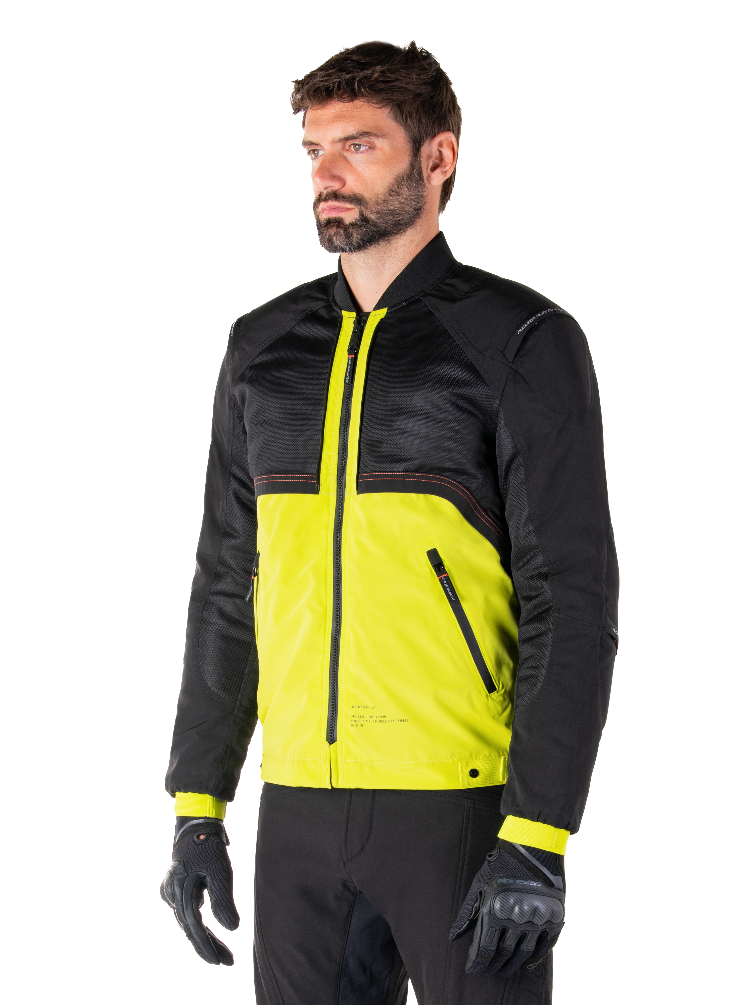 Alpinestars Mootant Waterproof Parka in Lime Punch Black, modular motorcycle jacket with a black mesh upper and vibrant lime green lower body, worn by a male rider with black gloves and pants, urban contemporary riding style.
