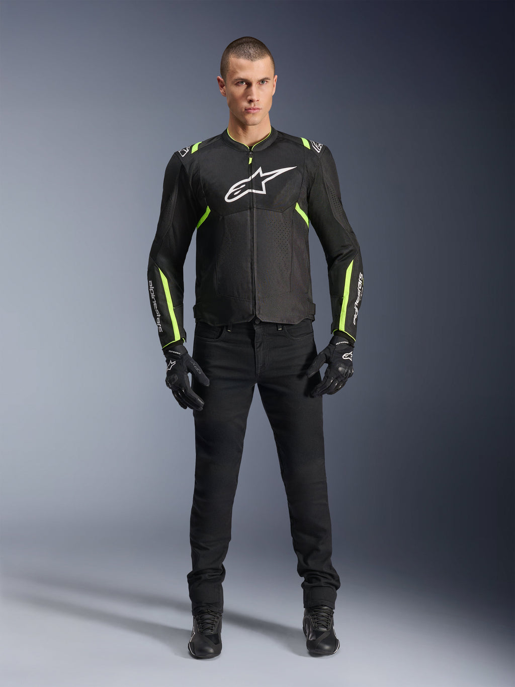 Alpinestars T-Sps Air V2 Jacket, Black and Yellow Fluo, textile motorcycle jacket with mesh paneling, worn by male model with black pants and gloves, featuring white Alpinestars logo on chest, urban sport riding gear