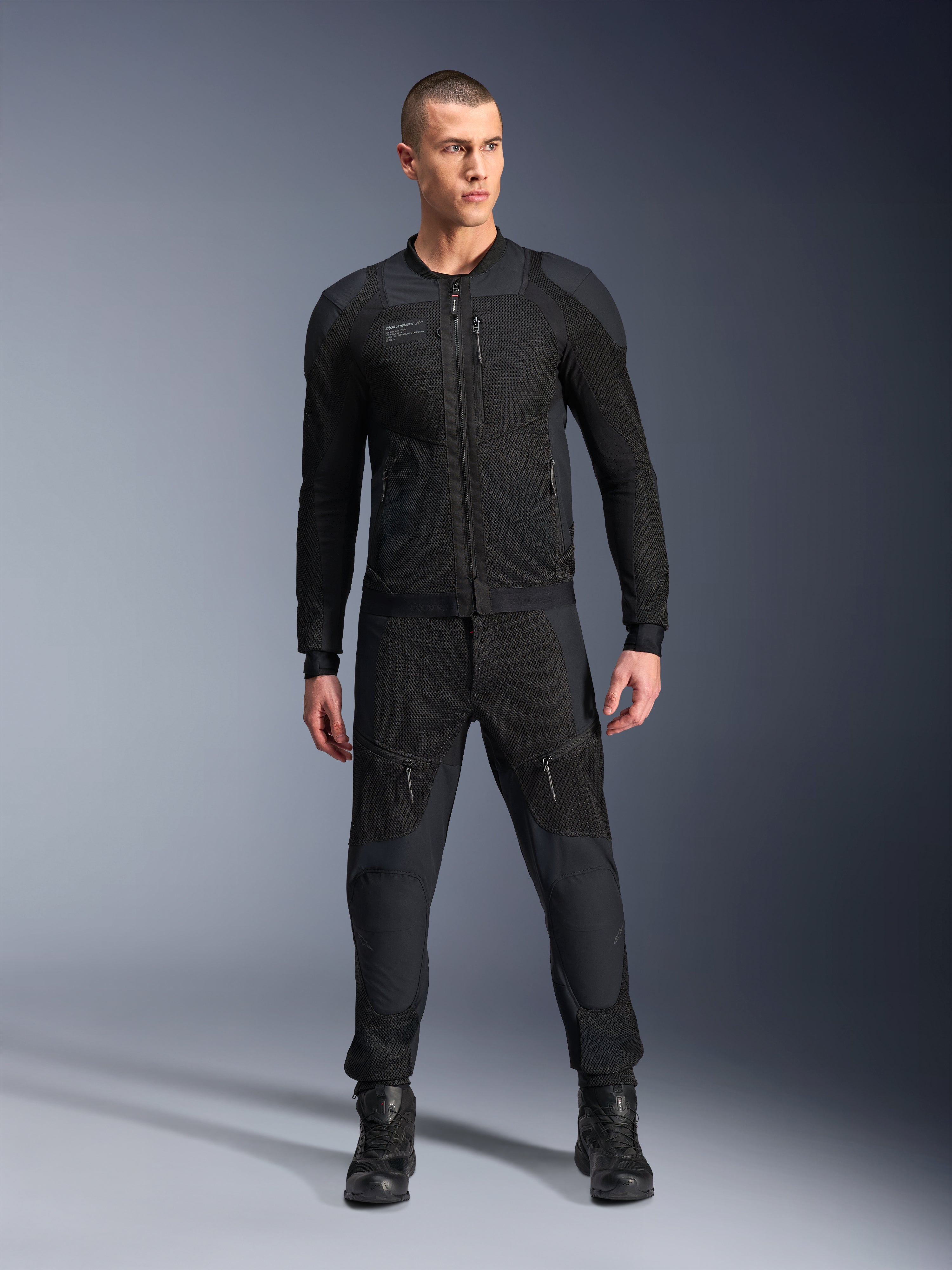 Alpinestars Troop-Air Pro Jacket, Black technical armored motorcycle jacket, featuring mesh panels and front zippers, worn with matching black pants and riding boots, premium urban road gear