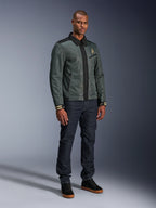 Alpinestars Ignite Air Jacket, Urban Gray Black Blue, urban motorcycle jacket, worn by a model with dark denim jeans and black sneakers, featuring a mesh body, traditional shirt collar, Harrington-inspired silhouette, and gold Alpinestars branding.