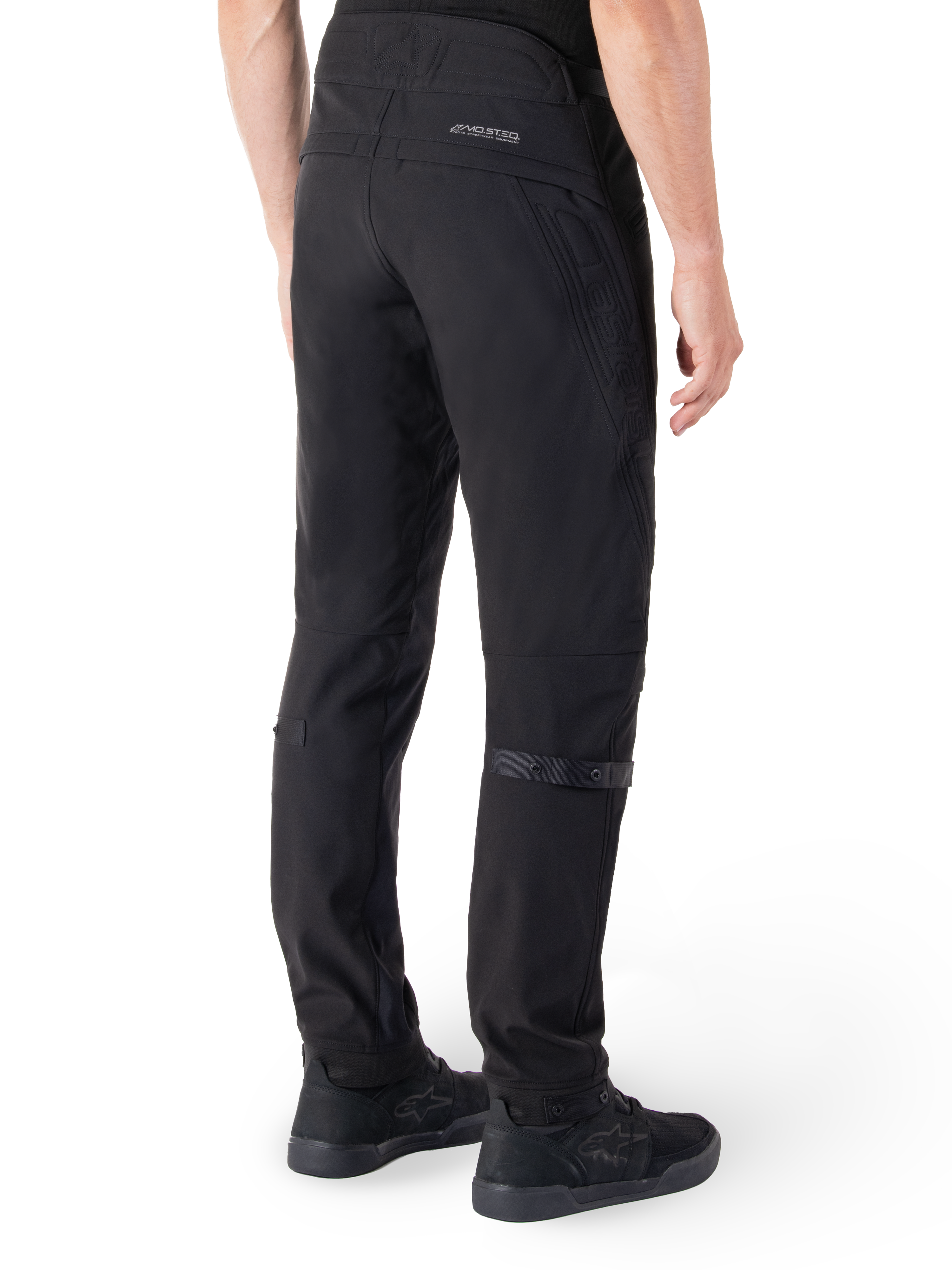 Alpinestars Alden Hose, Urbane Motorradhose, Schwarz, Rückansicht mit technischem Softshell-Gewebe und gesteppten Details, reflektierendes MO.ST.EQ.-Branding auf der Rückenpasse und verstellbare Wadengurte, kombiniert mit schwarzen Motorradschuhen