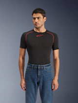 Alpinestars Flex-AST 5 Denim Hose in Indigo Washed, urbane Motorradjeans mit konischer Passform, getragen von einem männlichen Model mit schwarzem, kurzärmeligem Base Layer mit roten Akzenten, lässiges Road-to-Street-Styling