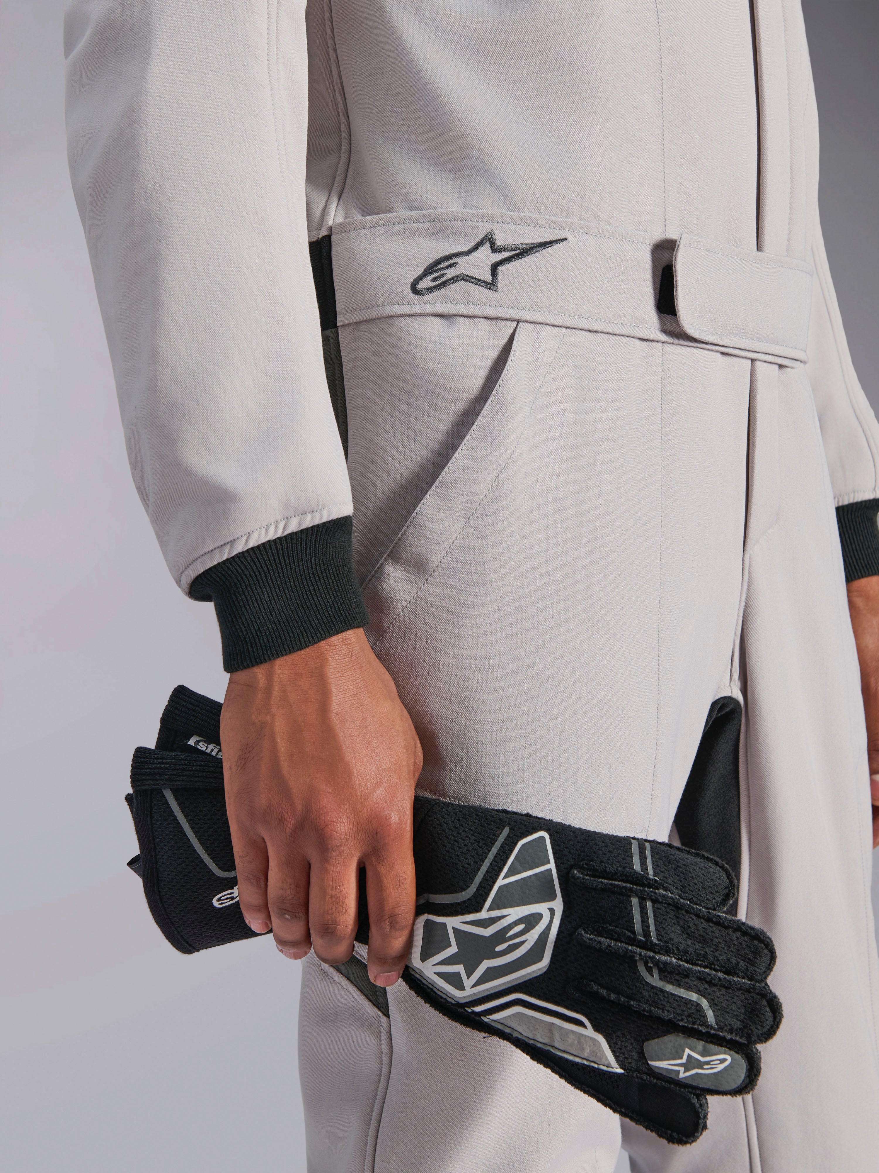 Alpinestars GP Race V3 Anzug FIA, Auto-Rennanzug, Silber Anthrazit, gehalten mit schwarzen Rennhandschuhen, verstellbarer Gürtelbund mit gesticktem Stern-Logo, schwarze Rippbündchen, sauberes und professionelles Motorsport-Design