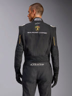 Rear view of the Alpinestars Limited Edition Lamborghini GP Tech V4 Suit, Black with Gold accents, featuring Automobili Lamborghini shield and 'SQUADRA CORSE' text on the back, professional FIA-certified racing suit for automotive competition