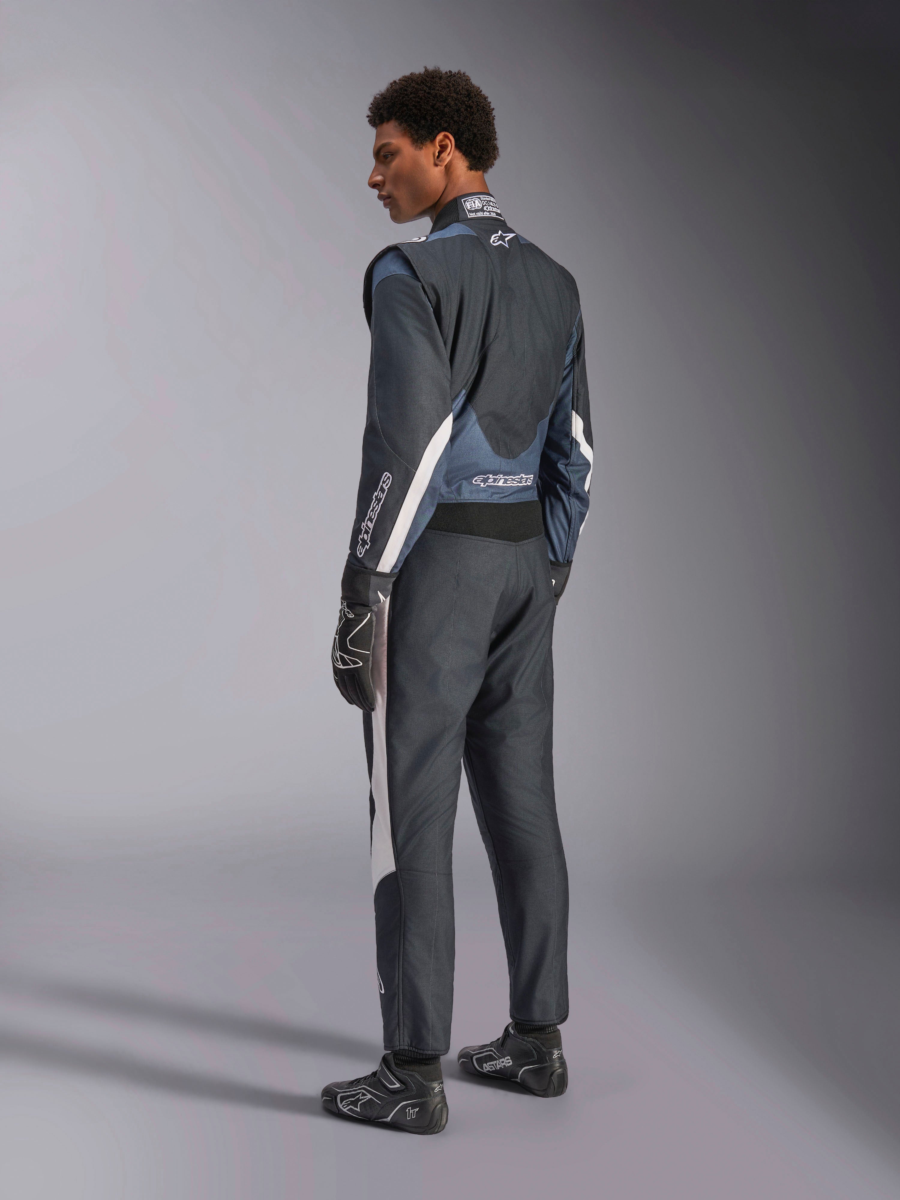 Alpinestars GP Pro Comp V2 FIA Auto Racing Suit in Black and Asphalt with white accents, rear 3/4 profile view.