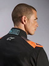 Alpinestars KMX-5 V3 Suit, Black and Orange Fluo, close-up of back collar and shoulder, featuring blue FIA 8877-2022 Grade 1 certification patch and white Alpinestars logo, technical mesh panels for breathability