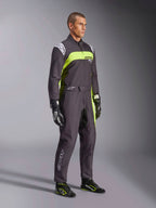 Male model wearing Alpinestars KMX-9 V3 Graphic 3 Suit in Black and Yellow Fluo, professional karting gear with vibrant neon yellow panels and white logo accents, accessorized with coordinated racing gloves and shoes, set against a studio background.