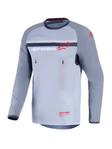 Alpinestars Maxdura Dual Jersey, Adventure Motorcycle Jersey, Mid Gray and Dark Gray, front view featuring vertical zippered chest pockets, abrasion-resistant sleeves with integrated padding, and Alpinestars branding in red and white, performance gear for off-road riding