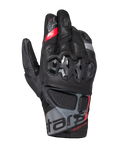 Alpinestars Belize V3 Drystar Gloves, short-cuff adventure motorcycle gloves, black with red and gray accents, featuring hard knuckle protection with a hexagonal pattern, perforated leather panels, and "ADVENTURE" branding on the wrist.