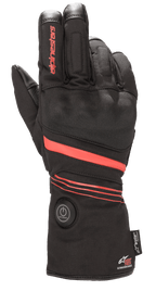 Alpinestars HT-5 Heat Tech Drystar® Handschuhe, Beheizte Motorradhandschuhe, Schwarz mit roten Akzenten, runder Power-Button an der Manschette, rote Streifen über Hand und Handgelenk, Alpinestars-Branding auf dem Finger, konzipiert für wasserdichten Kälteschutz