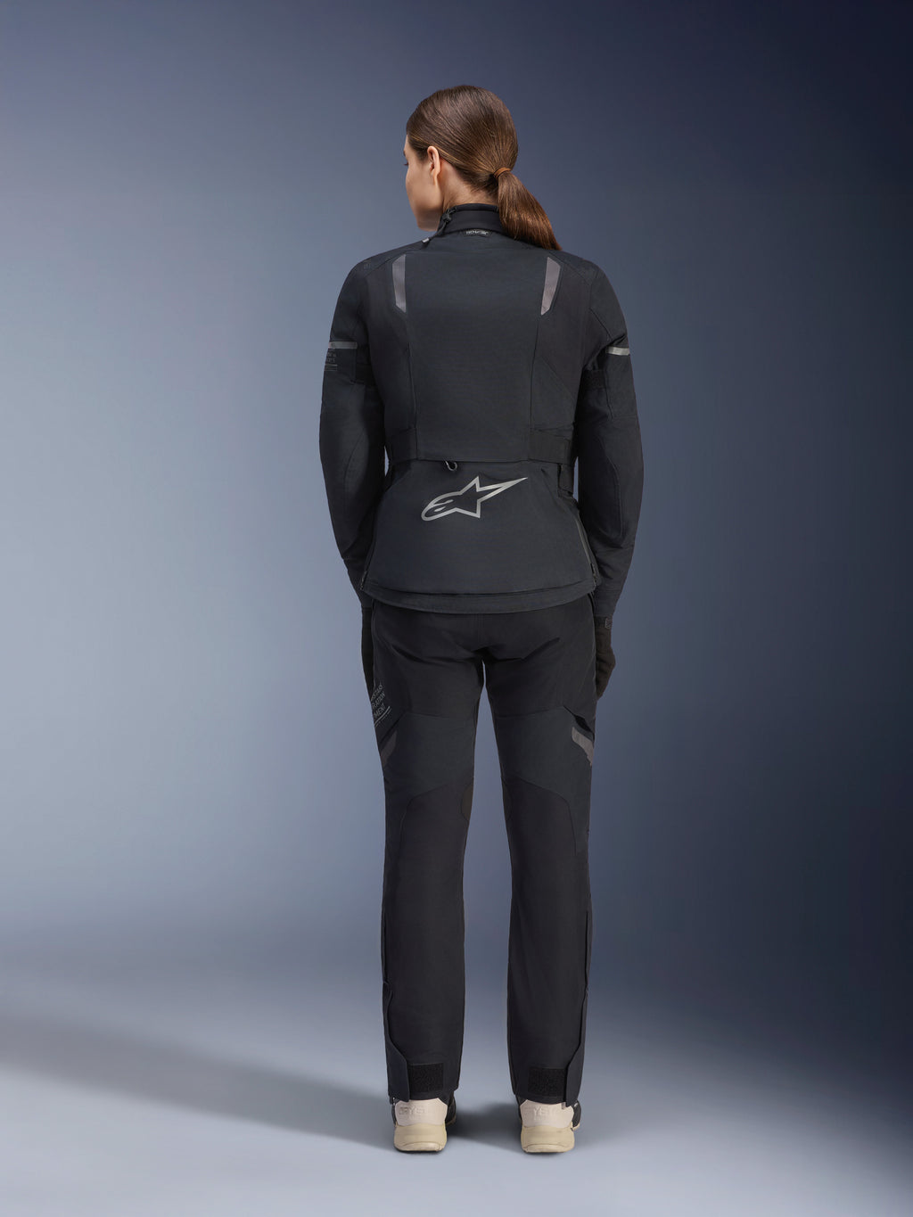 Alpinestars Stella ST-7 2L GORE-TEX Jacke und Hose, Motorrad-Adventure-Touring-Outfit für Damen, Schwarz und Dunkelgrau, Rückansicht mit Astar-Logo und reflektierenden Details, strapazierfähige wasserdichte Textilkonstruktion