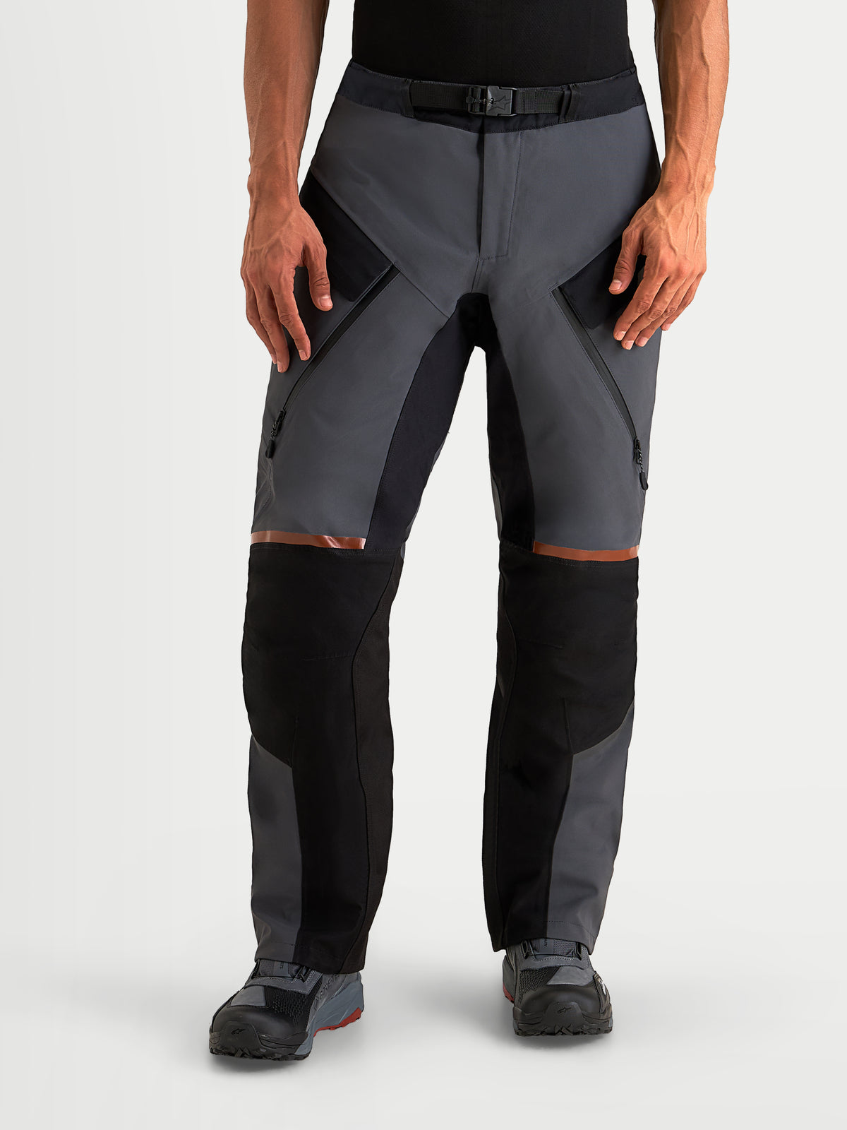 Alpinestars St-7 V2 2L Gore-Tex Pants, men's adventure touring motorcycle pants in deep gray and black, front view on a model showing waterproof textile construction, thigh ventilation zips, and CE AA certification