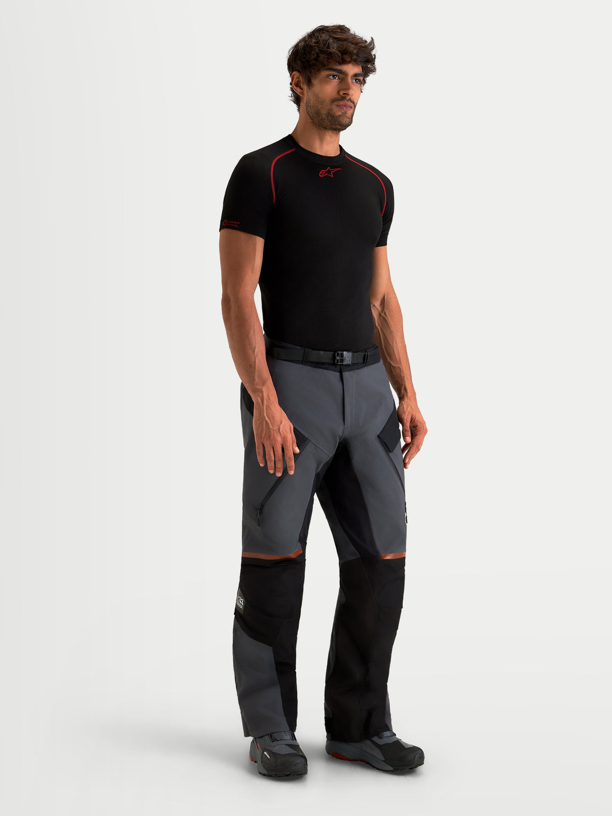 Alpinestars St-7 V2 2L Gore-Tex Pants, men's adventure touring motorcycle pants in deep gray and black, full-length view on a model wearing waterproof textile riding gear with zippered thigh vents.