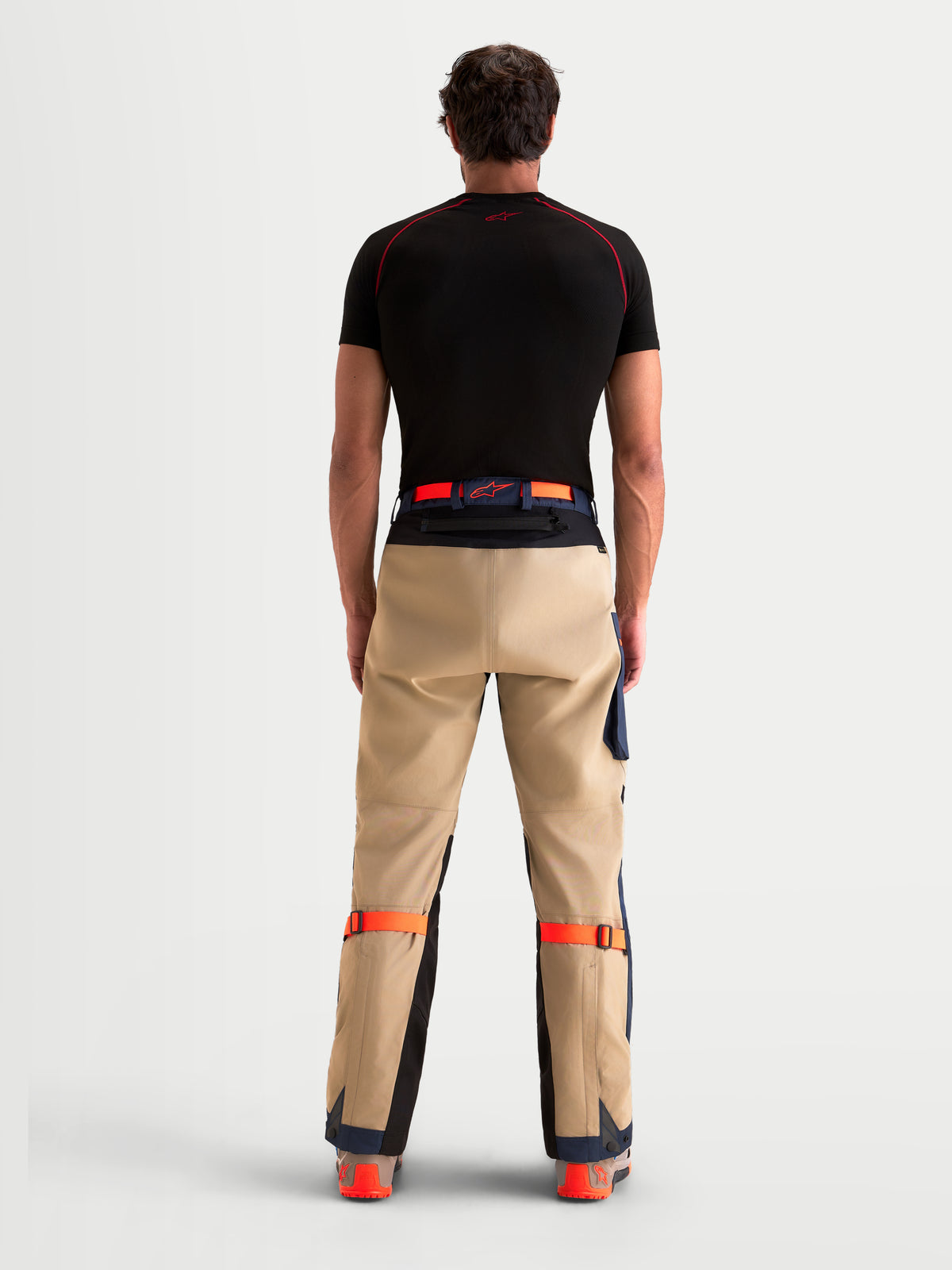 Alpinestars Arenis Gore-Tex Hose, Herren-Adventure-Motorradhose in Beige und Marineblau, Rückansicht an einem Model mit Taillengürtel und verstärkter 3L-Gesäßkonstruktion