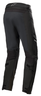 Alpinestars Road Tech GORE-TEX Hose Short, Schwarz, 3/4-Rückansicht mit Taillen-Verbindungsreißverschluss, verstellbaren Wadengurten und ballistischen Nylon-Verstärkungen, wasserdichte Adventure-Touring-Ausrüstung