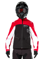 Alpinestars Lite-Dura Softshell Jacket in Black Bright Red and White, worn by a motocross rider with a black helmet and red-tinted goggles, featuring white panels on the sleeves, Alpinestars branding on the chest, and a sporty off-road design.