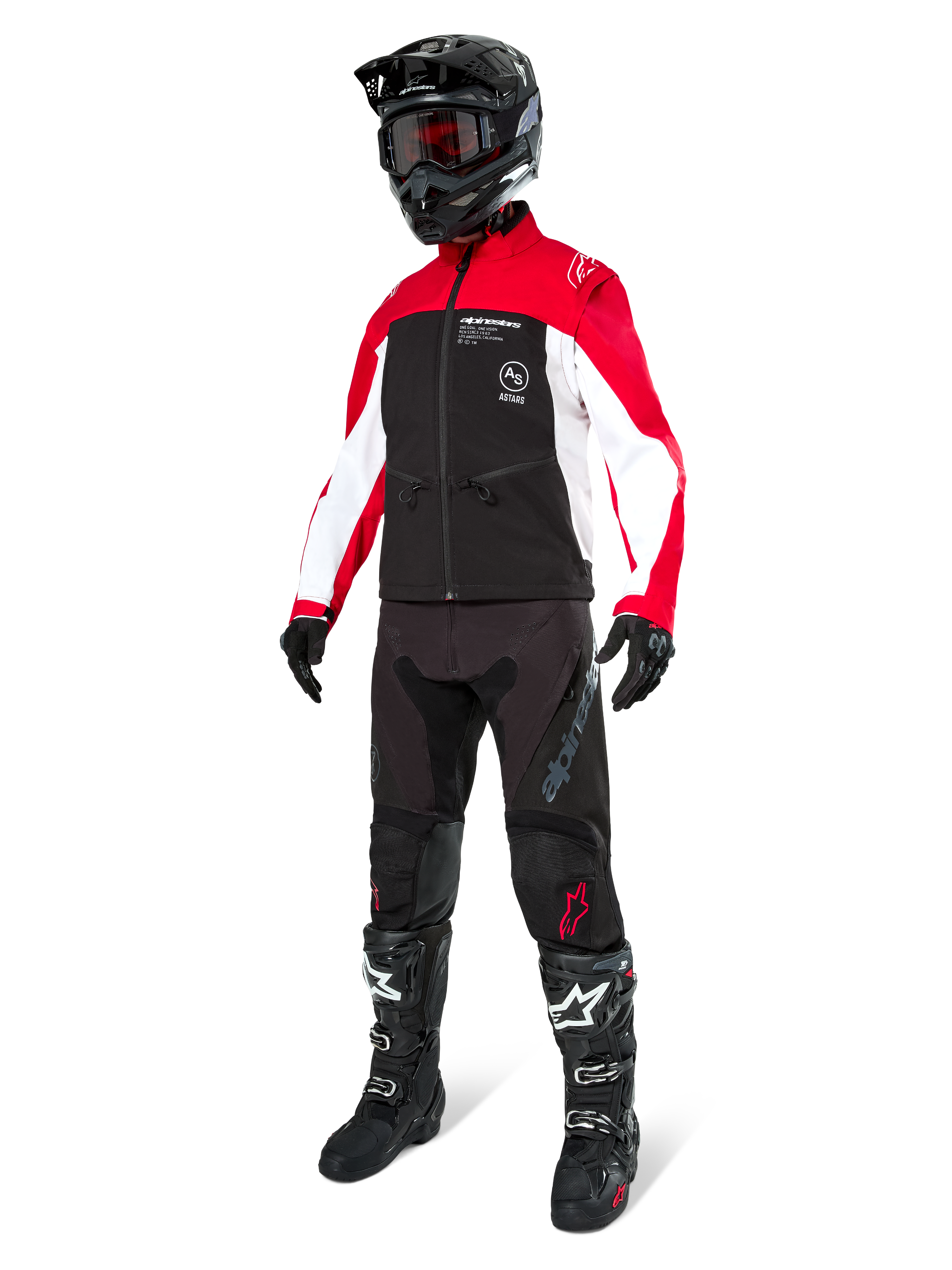Motocross rider wearing the Alpinestars Lite-Dura Softshell Jacket in Black, Bright Red, and White, featuring a black body with red and white sleeves, paired with black pants, a black helmet with red goggles, and black and white boots, complete off-road racing outfit.