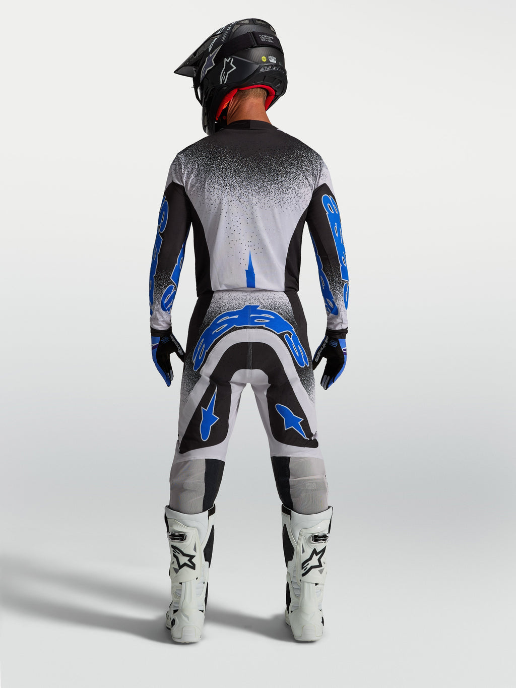 Alpinestars Supertech Hiten AFD Hose, Herren-Motocross-Rennbekleidung in Blau und Weiß, athletische Rückansicht.